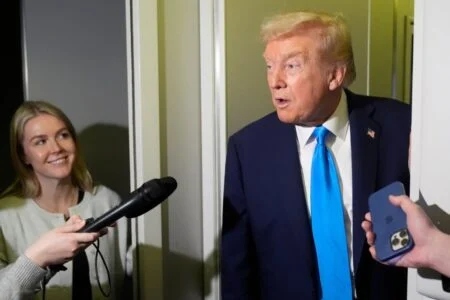 Trump Announces Additional 10 Per Cent Tariff On Canada Over Ontario Ad President Donald Trump speaks with reporters as White House press secretary Karoline Leavitt listens aboard Air Force One at Al Udeid Air Base in Doha, Qatar, Saturday, Oct. 25, 2025. (AP Photo/Mark Schiefelbein)