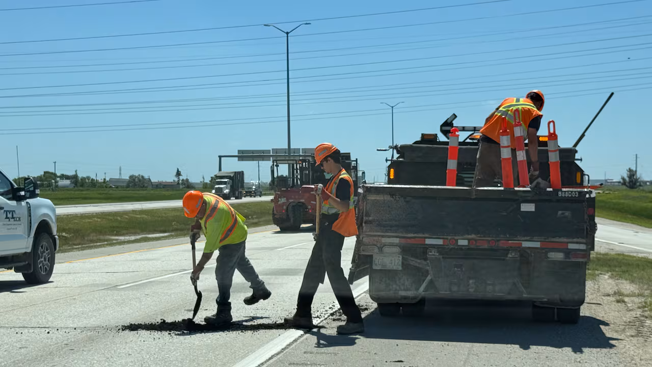 Manitoba Highways Buckled And Broke Under Extreme Heat — And One Driver'S Car Paid The Price 1 Construction workers repairing a highway.