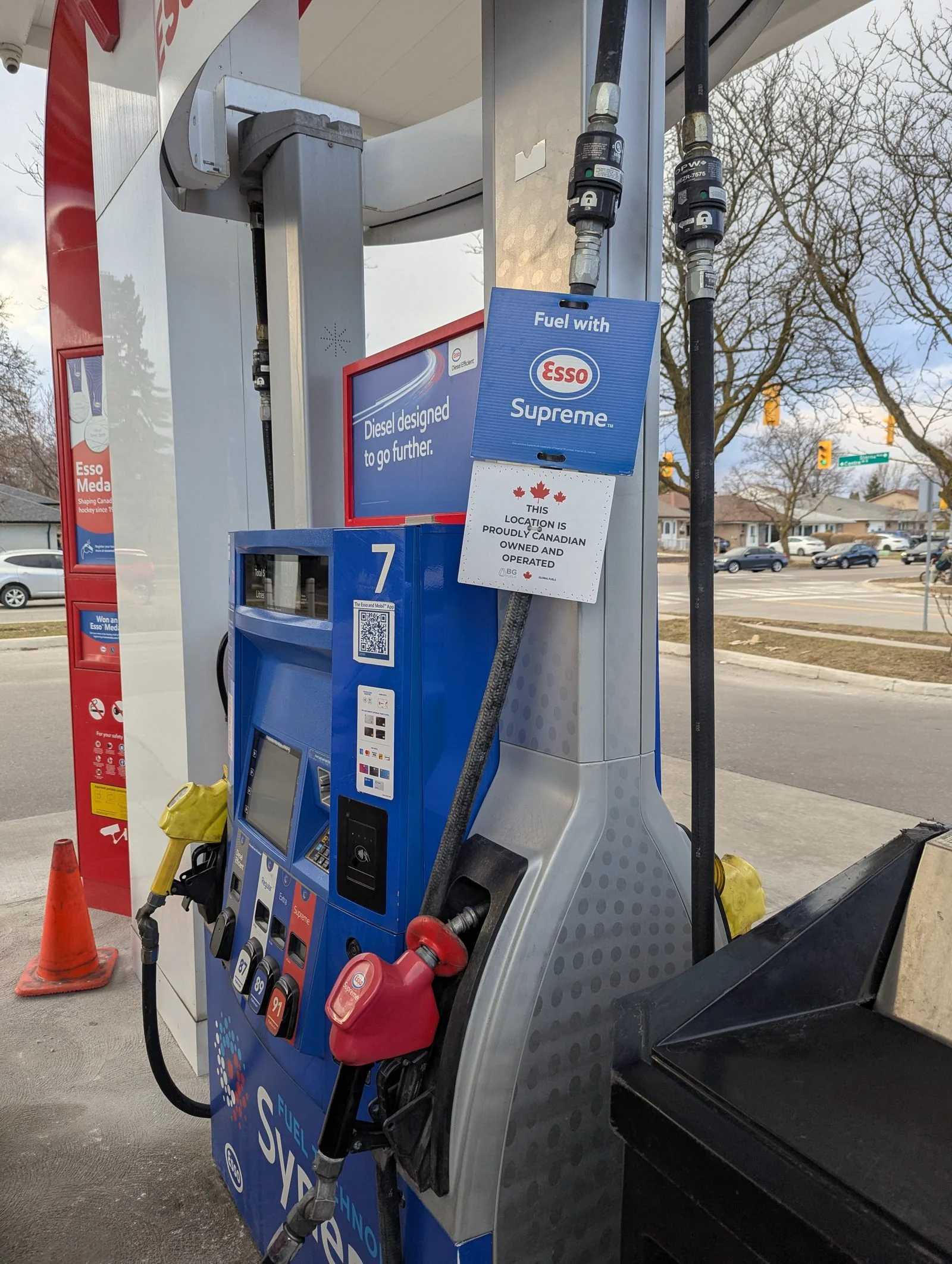 Alberta Fuel Tax Cut 2026 — Smith Axes The 13-Cent Levy Oct. 1 As A $9.4B Deficit Flips To A $2B Surplus 3 A fuel pump at a Canadian Esso station — the Alberta Fuel Tax suspension covers both gasoline and diesel