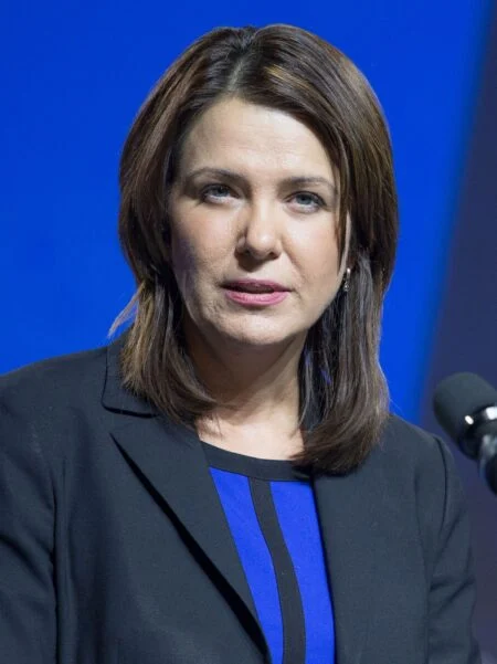 Alberta Health Premium 2026 — Danielle Smith Floats $1,900 Fee For Temporary Residents Alberta Premier Danielle Smith at the centre of the Alberta Health Premium debate over a $1,900 charge for temporary residents.