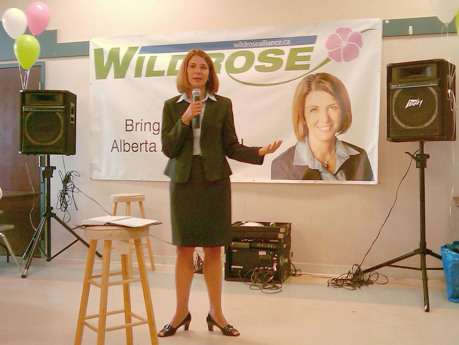 Alberta Health Premium 2026 — Danielle Smith Floats $1,900 Fee For Temporary Residents 1 Danielle Smith speaking at a public event in Edmonton