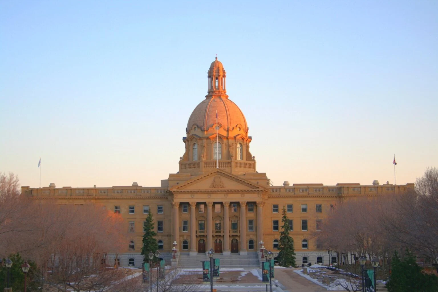 Alberta Ndp Launches Court Challenge Over Voter-List Rules — Fraud Fears Cloud Oct. 19 Referendum The Alberta Legislature Building in Edmonton at sunset, seat of the government whose voter-list rules the Alberta NDP is challenging