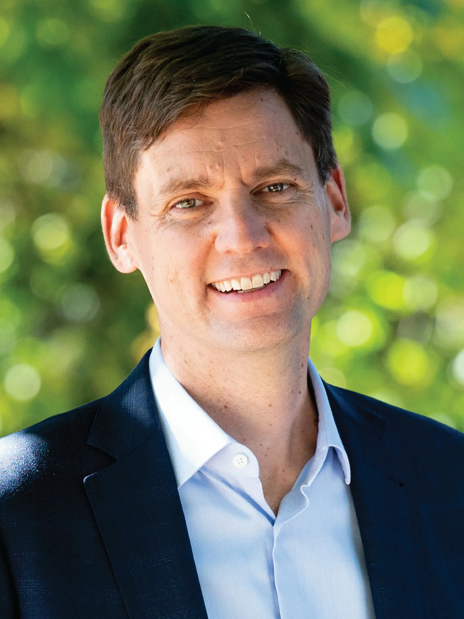 B.c. Snap Election 2026 — Eby Calls Oct. 24 Vote Over Trump'S Trade War 1 B.C. Snap Election 2026: Portrait of B.C. Premier David Eby smiling in a suit against a blurred green background