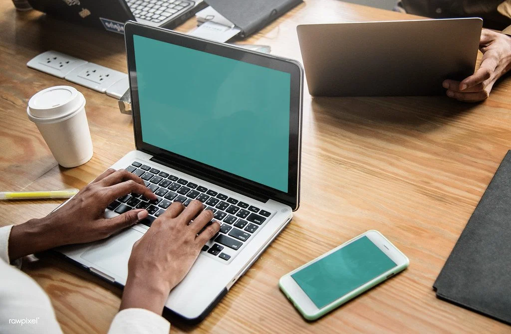 Bridging Open Work Permit Canada 2026 — Keep Working While You Wait For Your Pr Professionals working together on a laptop in a meeting