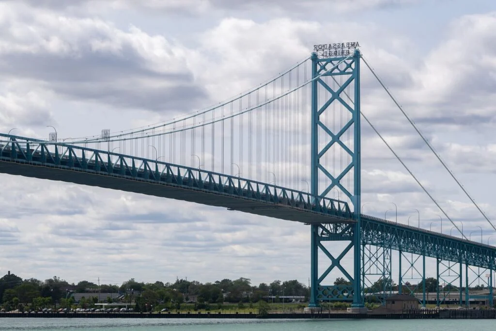Cbsa Essex County Firearms Bust 2026 — 53 Guns Seized, Man Charged In Cross-Border Smuggling Ring The Ambassador Bridge between Windsor and Detroit amid the Essex County Firearms Bust crackdown at the border.