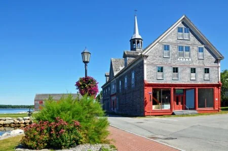 Compass Nova Scotia Co-Op Homes 2026 — Old Schools And Halls Become 13 Affordable Homes Historic Cox's Warehouse on the Shelburne waterfront, an example of the heritage buildings Compass Nova Scotia Co-op Homes is converting into affordable housing
