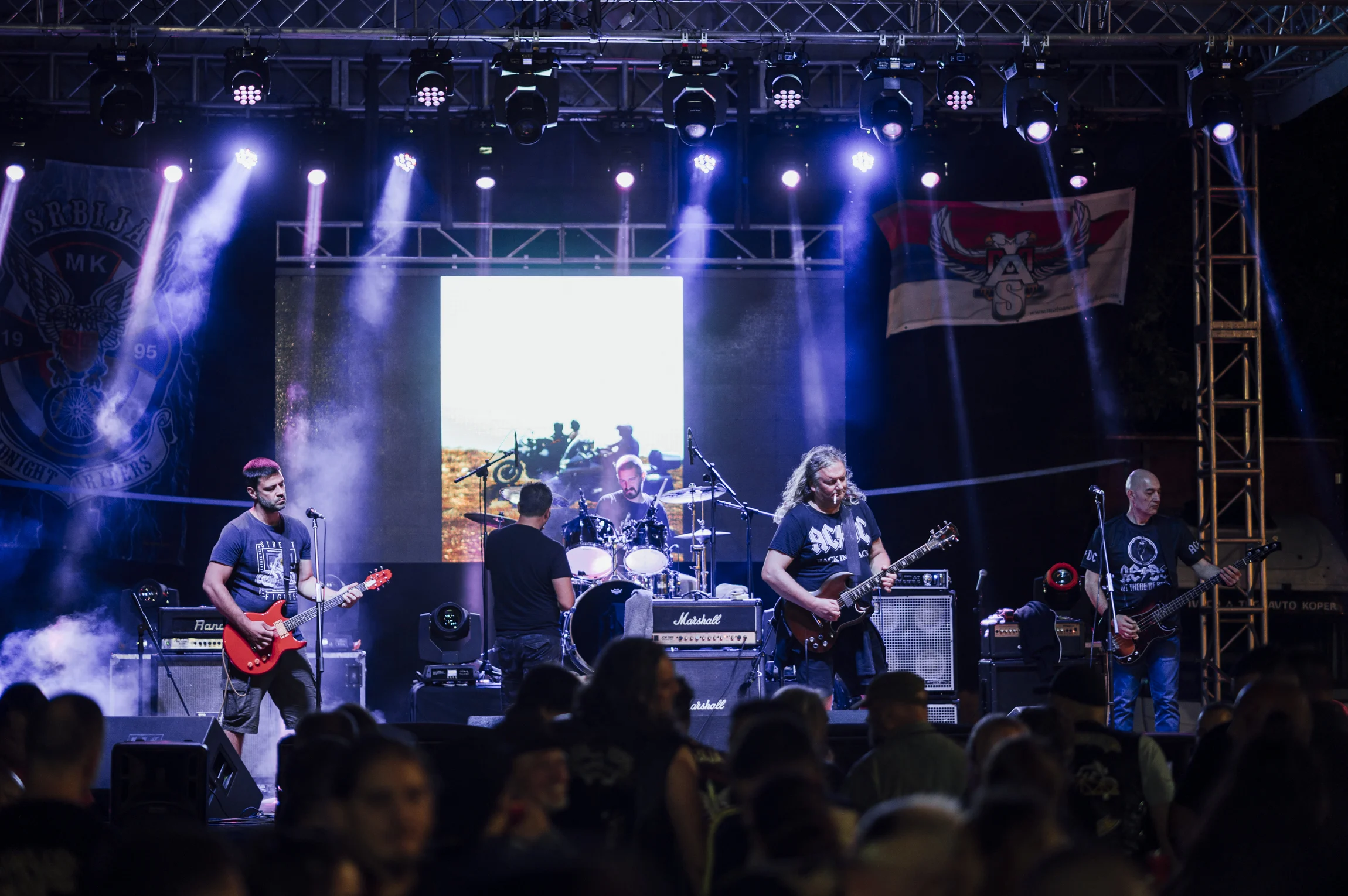 Winnipeg Concerts Fall 2026 — Arena Rock, The Burton Cummings Theatre'S Packed Autumn And A Sold-Out Symphony Night 2 Crowd watching musicians perform on stage at an outdoor concert under colourful lights