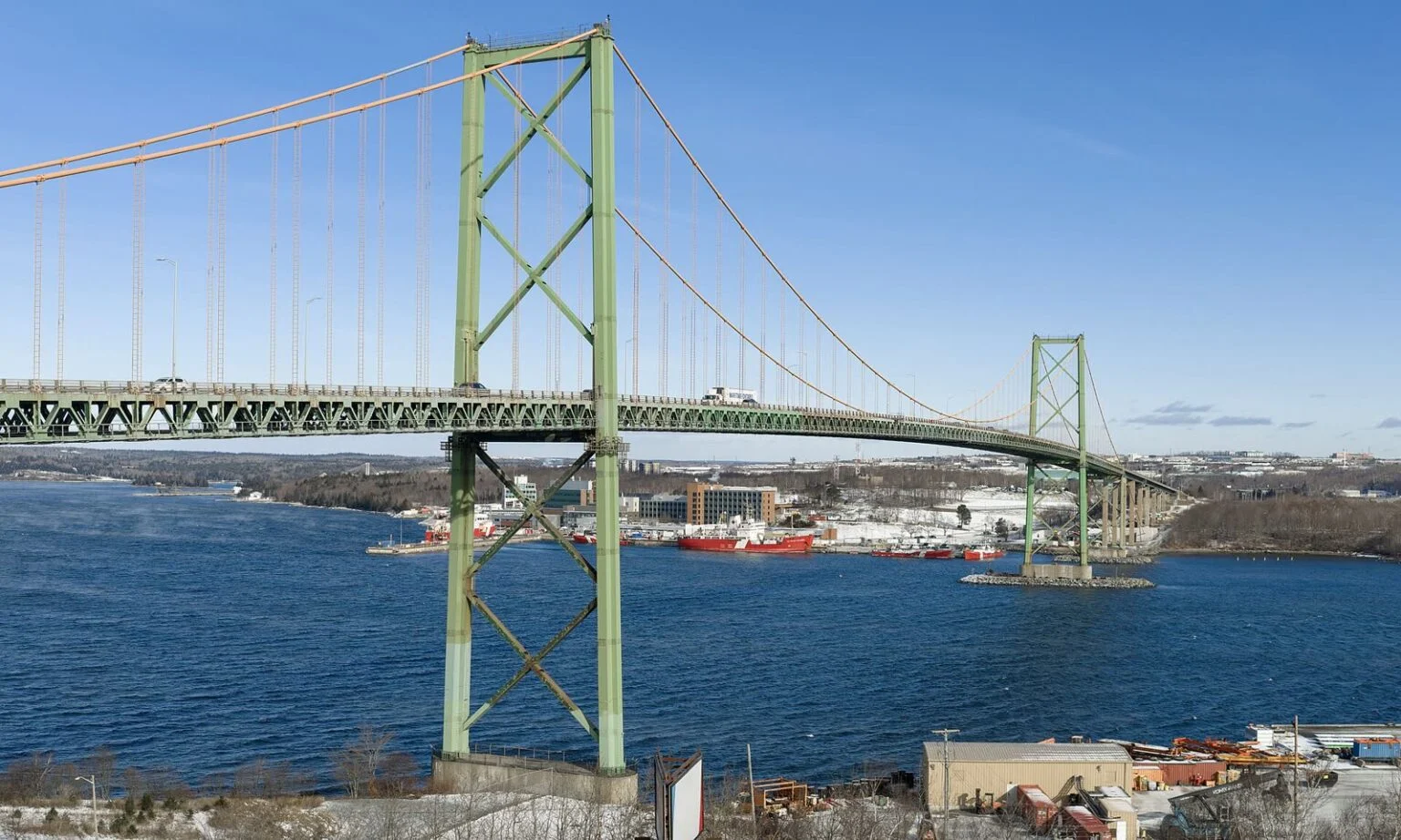 Nova Scotia Mackay Bridge Replacement Study 2026 — Repair, Rebuild Or Tunnel For Halifax Harbour? MacKay Bridge replacement: The A. Murray MacKay Bridge spanning Halifax Harbour, seen from the Halifax side with its distinctive green suspension towers