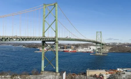 Nova Scotia Mackay Bridge Replacement Study 2026 — Repair, Rebuild Or Tunnel For Halifax Harbour? MacKay Bridge replacement: The A. Murray MacKay Bridge spanning Halifax Harbour, seen from the Halifax side with its distinctive green suspension towers
