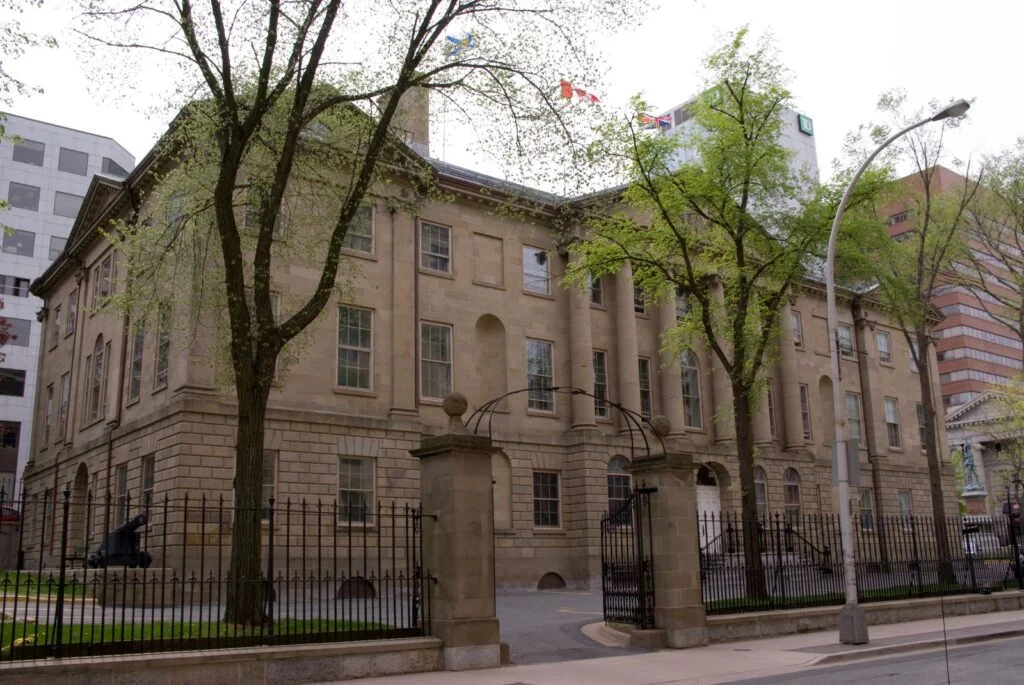 Nova Scotia Record Deficit 2026 — $1.4 Billion Shortfall, Largest In Provincial History Province House in Halifax, seat of the legislature facing the Nova Scotia Record Deficit.