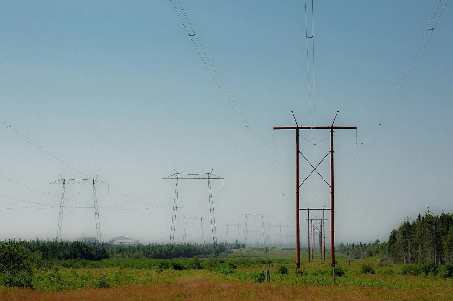 Point Lepreau Shutdown Heavy Water Leak 2026 — 200 Litres Lost, Plant Down Again Power lines at the Point Lepreau nuclear station site during the Point Lepreau Shutdown Heavy Water Leak outage