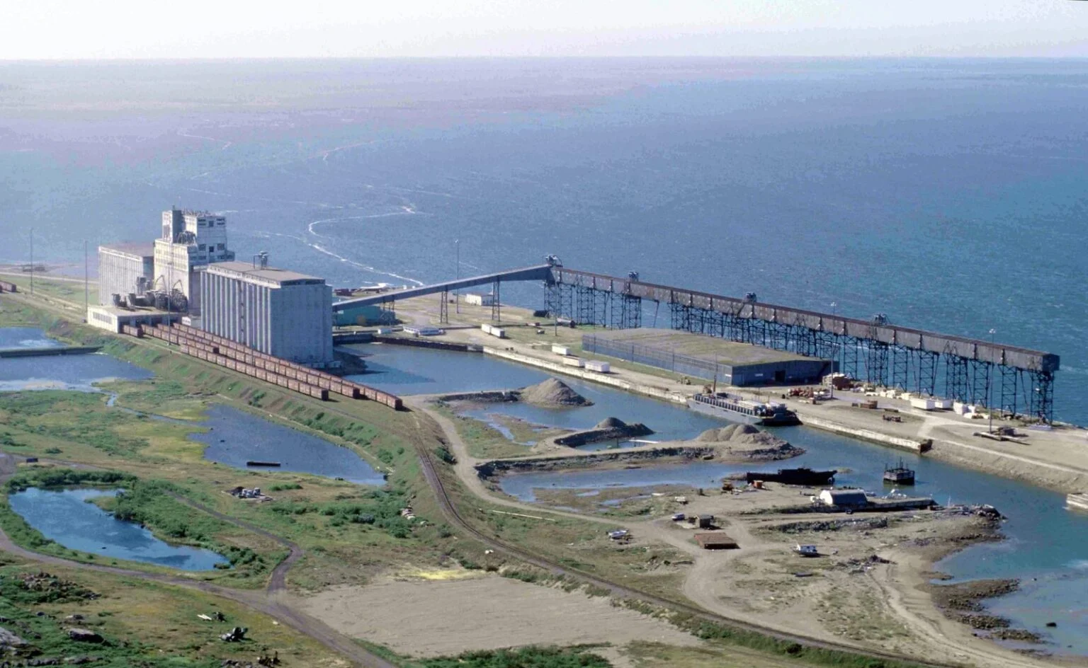 Port Of Churchill Expansion 2026 — Owner Says $3B Beats Kinew’S $80B Lng Plan Aerial view of the Churchill seaport grain terminal and loading trestle on Hudson Bay, at the centre of the Port of Churchill Expansion debate