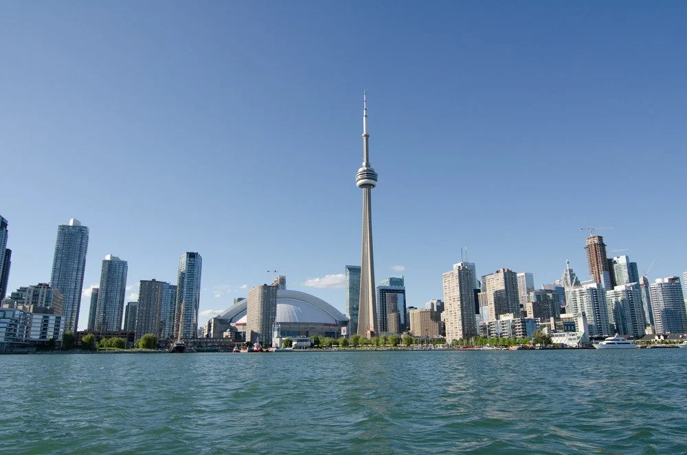 How To Get Permanent Residency Faster In Canada — 9 Strategies That Actually Work In 2026 Toronto skyline with the CN Tower