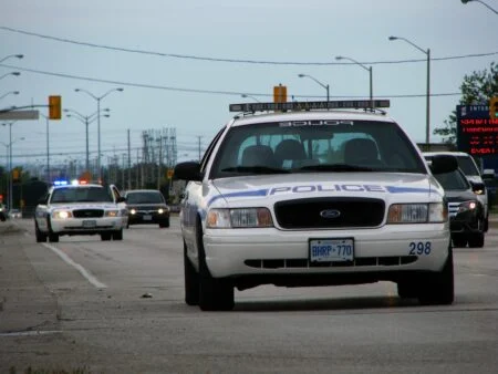 Project Red Zone Ontario 2026 — Peel Police Bust Gta Firearm Trafficking Network Tied To 14 Shootings Project Red Zone Ontario: Peel Regional Police cruisers on a street in Malton, Ontario