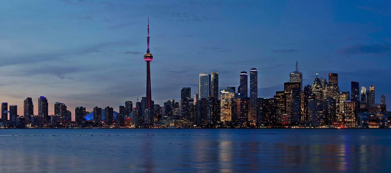 Project Red Zone Ontario 2026 — Peel Police Bust Gta Firearm Trafficking Network Tied To 14 Shootings 3 Project Red Zone Ontario: Toronto skyline with the illuminated CN Tower at dusk