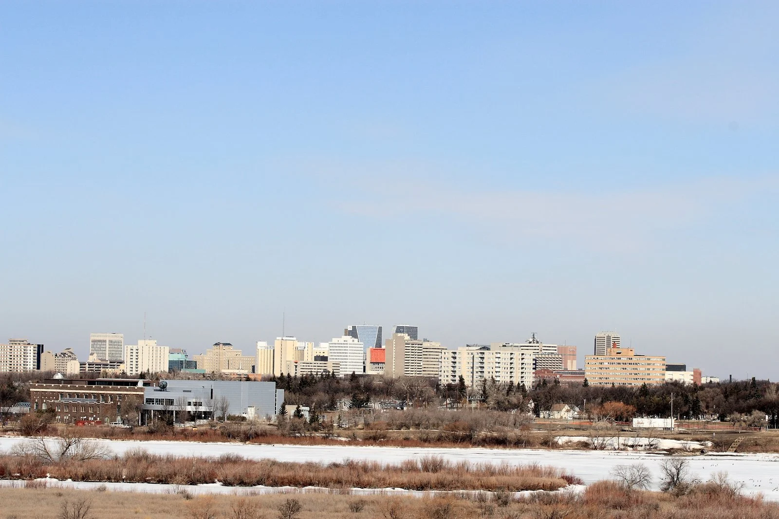 Saskatchewan Protective Services Memorial 2026 — Regina Unveils Permanent Tribute To Fallen Heroes 2 Regina Saskatchewan skyline seen across Wascana Lake