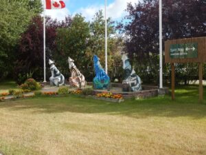 Manitoba’S Thompson Safe Space 2026 — $8M Northern Lodge For Indigenous Women And Children Thompson Safe Space — Spirit Way wolf statues in downtown Thompson, Manitoba