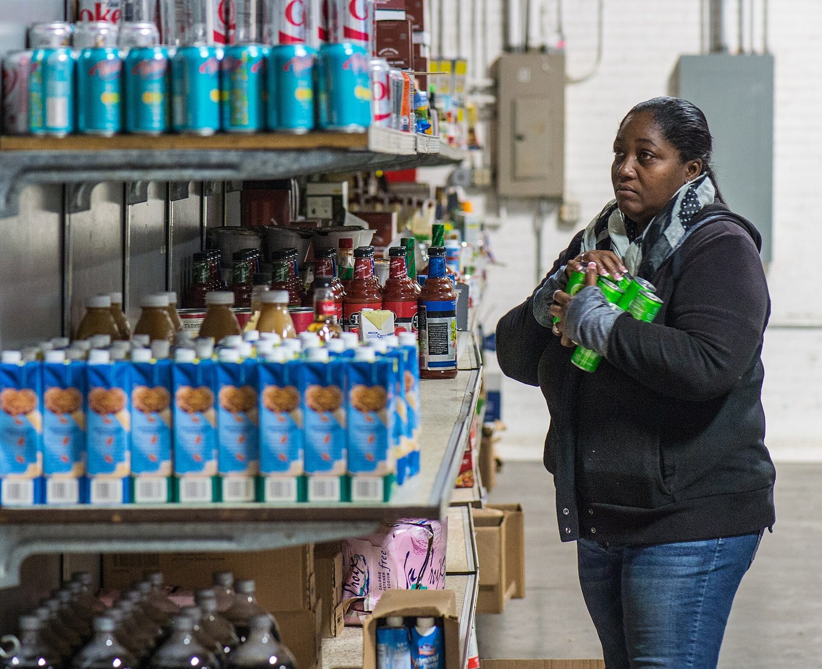 Montreal Hungercount 2026: Food Bank Demand Hits A Record 1.25 Million Monthly Requests 2 A shopper at stocked food bank shelves as Montreal HungerCount 2026 reports chronic need