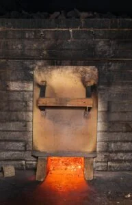 Cedar Stone Thermal Spa 2026 — A Wolastoqiyik-Owned Wellness Destination Rises In Rusagonis Wood-fired smoke sauna stove glowing with embers, like the saunas planned for the Cedar Stone thermal spa