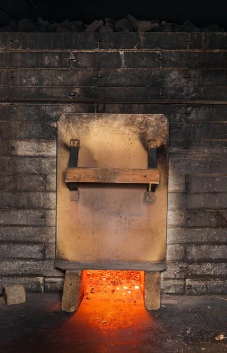 Cedar Stone Thermal Spa 2026 — A Wolastoqiyik-Owned Wellness Destination Rises In Rusagonis Wood-fired smoke sauna stove glowing with embers, like the saunas planned for the Cedar Stone thermal spa