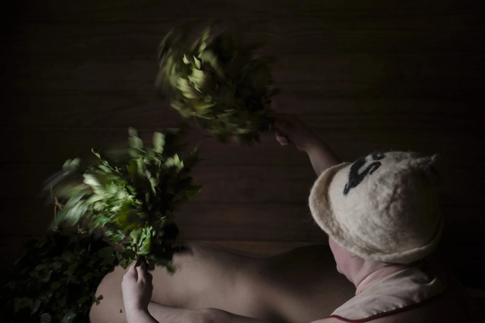 Cedar Stone Thermal Spa 2026 — A Wolastoqiyik-Owned Wellness Destination Rises In Rusagonis 1 A sauna-goer using birch whisks in a traditional sauna, the kind of thermal ritual the Cedar Stone thermal spa will bring to New Brunswick