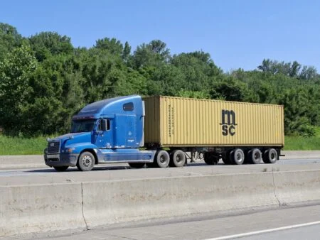 Semi-truck hauling freight on a Canadian highway — N.B. Diesel Prices 2026 hit truckers hard