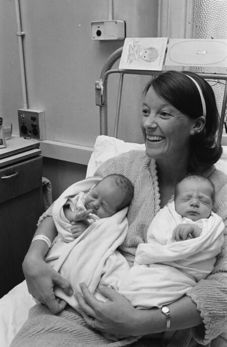 Rsv Immunization For Newborns 2026 — New Brunswick Makes It Free For Every Baby A smiling mother holds her twin newborns in a hospital bed — RSV Immunization for Newborns is now free for every New Brunswick baby