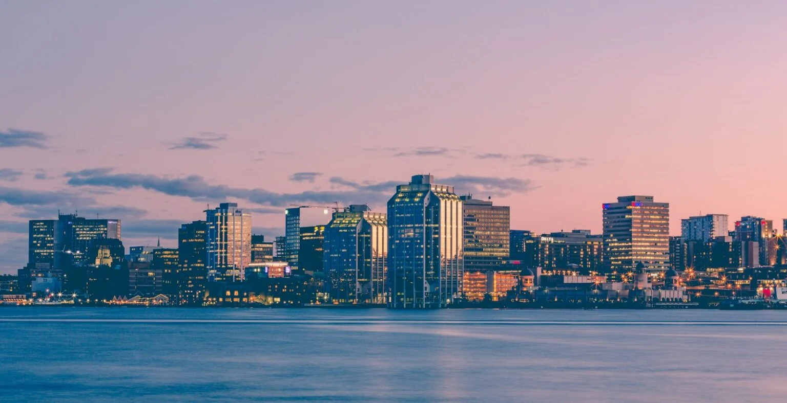 Indigenous-Led Projects Nova Scotia 2026: Ottawa Invests $3.3M In Nine Mi’Kmaq Ventures Halifax harbour sunset skyline, the city where the Indigenous-Led Projects announcement was made on Oct 21, 2026