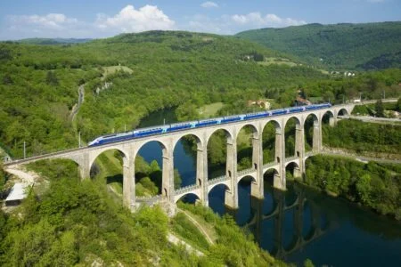 Canada’S High-Speed Rail Dream Just Got A $113 Billion Reality Check 2026 — Pbo Says Overruns “More Likely” A TGV Duplex high-speed rail train crossing the Viaduc de Cize-Bolozon in France, the kind of service at the centre of Canada's $113 billion high-speed rail debate
