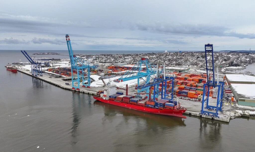 Saint John Trade Corridor 2026: Ottawa Puts $254M Into N.b. Port And Rail Upgrades Port of Saint John container terminal in New Brunswick with cranes and a container ship